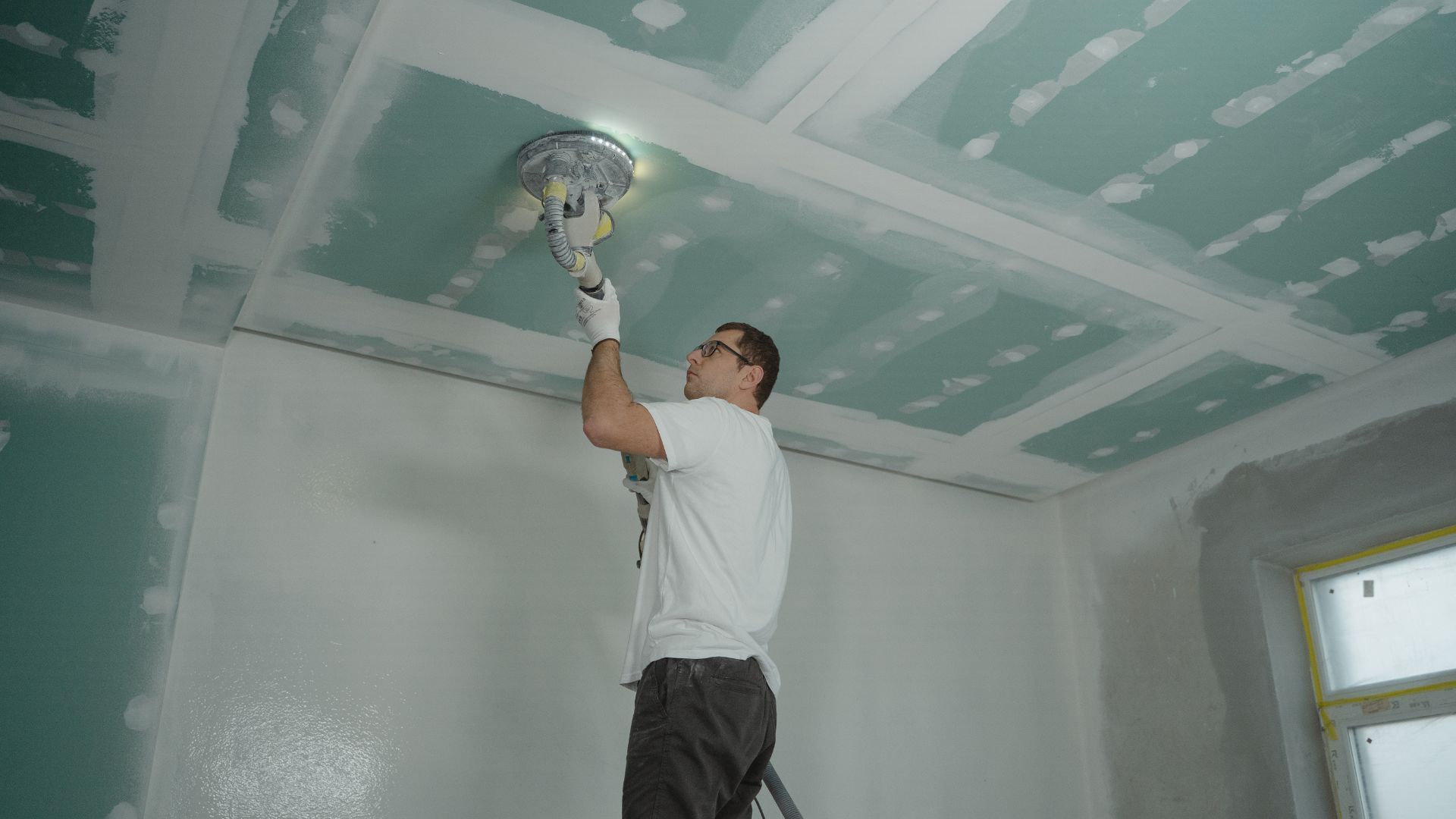 A man working on a ceiling
