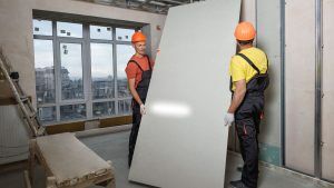 two men installing a drywall